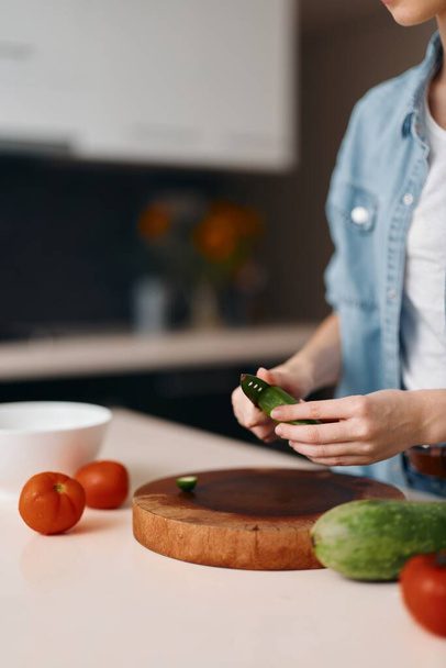 Свіжа і здорова вегетаріанська страва: жінка шеф-кухар готує смачний органічний салат на кухні - Фото, зображення