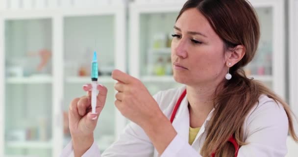 Doctor holding syringe with blue medicine in clinic 4k movie slow motion. Vaccination concept - Materiał filmowy, wideo