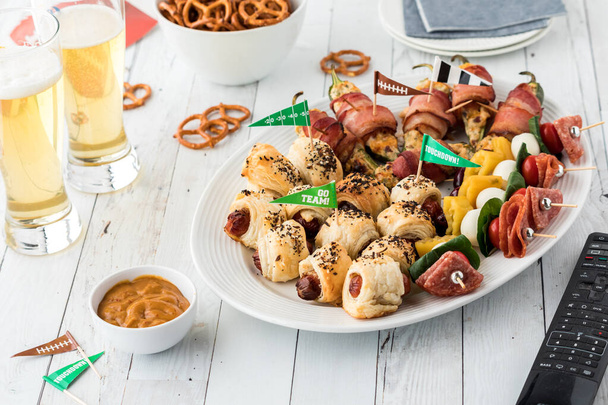 A platter of assorted game day appetizers served with beer, ready for sharing.  - Photo, Image