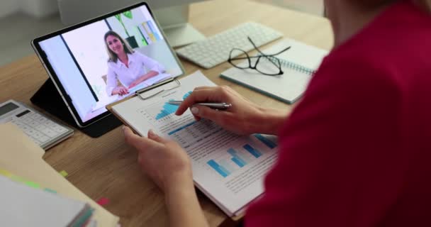 Businesswoman with documents communicating with colleague online via video link using digital tablet closeup 4k movie. Remote work with partners concept - Video, Çekim