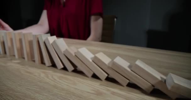 Hand stopping falling wooden blocks on table closeup 4k movie slow motion. Risk and strategy in business concept - Filmati, video