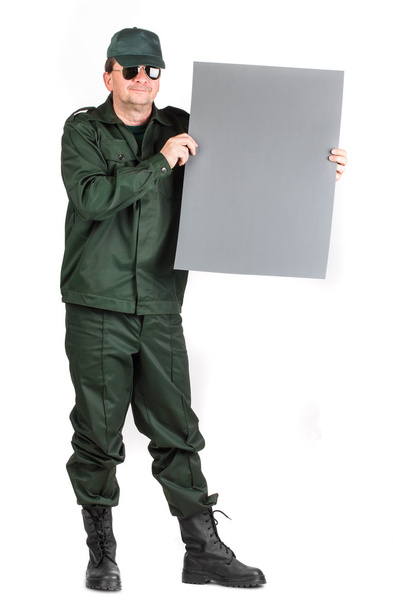 Man in workwear stands with paper. - Photo, image