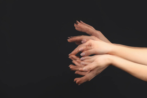 Stroboscopic photo of female hands moving on dark background - Foto, imagen