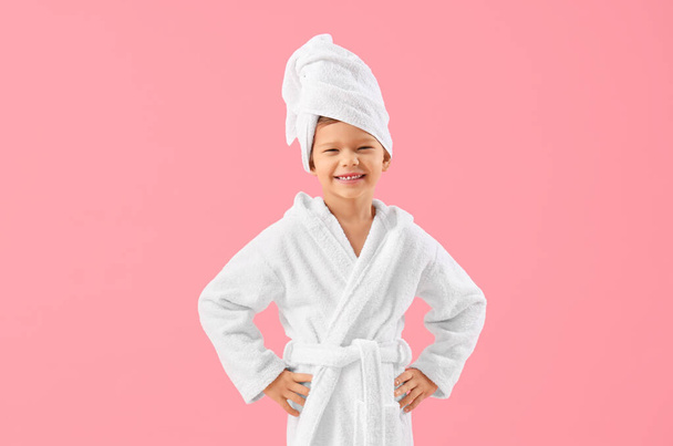 Cute little boy in bathrobe after shower on pink background - Foto, Bild