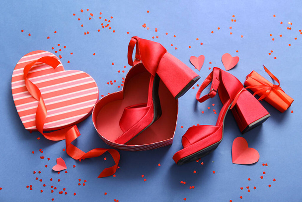 Composition with stylish female shoes, gift box and decor for Valentine's Day celebration on color background - Valokuva, kuva
