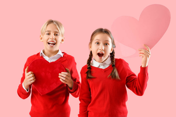 Little children with gift for Valentine's day and speech bubble on pink background - Zdjęcie, obraz