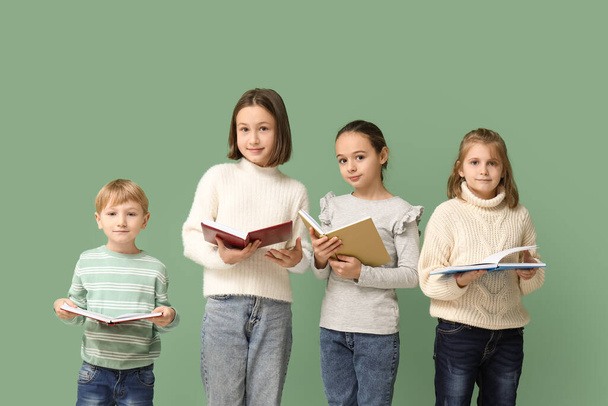 Little children reading books on green background - Foto, Imagem