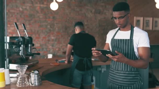 Man, cashier and cafe tablet for restaurant management or customer service at POS counter. Portrait or face of entrepreneur, man or barista arms crossed on digital technology at coffee shop startup. - Video