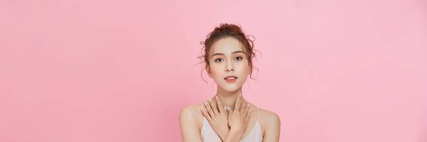  beauty Asian woman with beauty makeup showing fresh and clean skin isolated on pink background - Fotoğraf, Görsel
