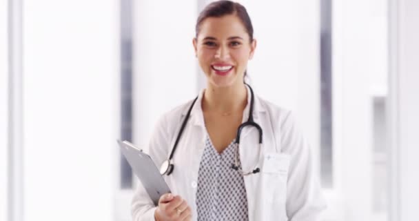 Doctor, woman and smile with checklist, face and career with consultation, healthcare and wellness at clinic. Professional medic, clipboard and happy with documentation, report or hospital paperwork. - Footage, Video