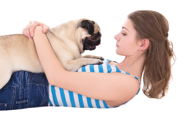 young woman playing with pug dog isolated on white  - Fotó, kép