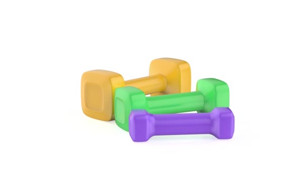 Three dumbbells with different sizes and colors on white background - Footage, Video