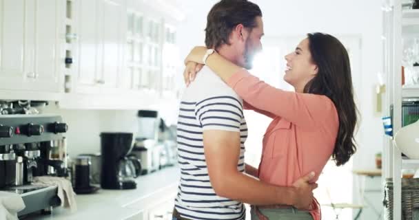 Happy man, woman and dancing in kitchen for fun, bond and relationship with love. People, married or couple with laugh for funny joke, silly and goofy for activity, celebration and energy in home. - Footage, Video