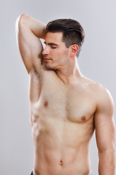 Handsome man smells under armpit - Photo, image