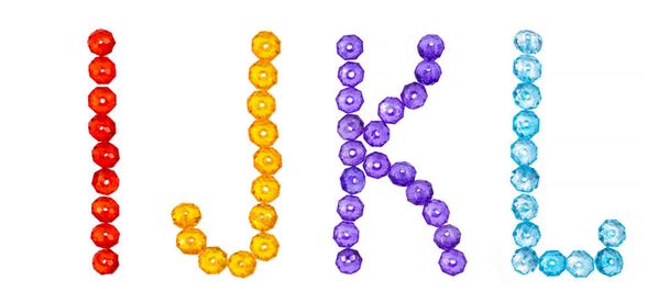 letters of the English alphabet laid out from colored beads on a white background, isolated alphabet - Photo, Image