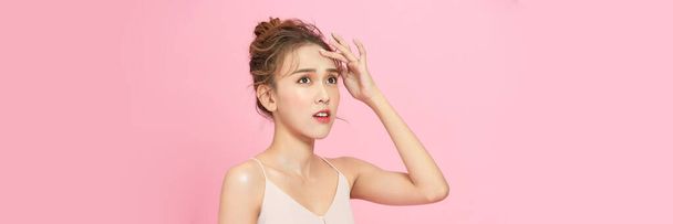 Beauty head shot of young asian woman on pink pastel background - Foto, Imagen