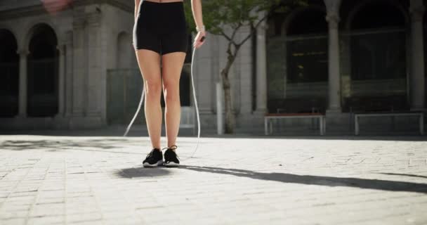 Feet, woman and skipping in city for fitness, health or training in summer, body transformation or street. Girl, road or sidewalk for rope, jump or outdoor exercise with workout, wellness or sneakers. - Footage, Video