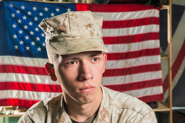 Людина в Армійське обмундирування на фоні прапора США - Фото, зображення