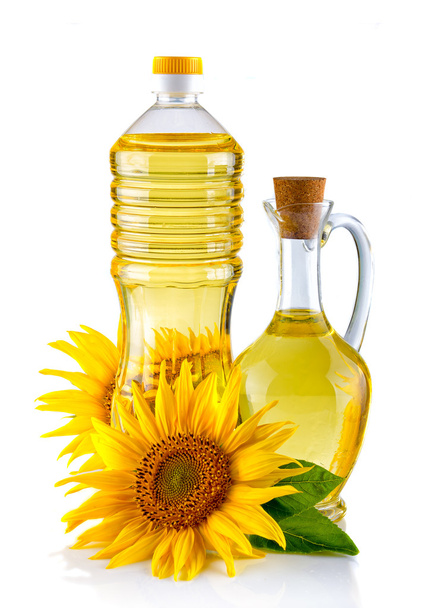 Jug and Bottle of Sunflower oil with flower isolated on white - Photo, Image