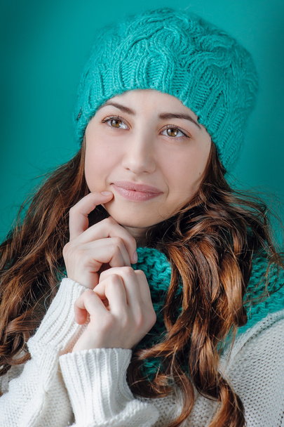 Portrait of a beautiful woman in a knitted hat in the studio - Photo, Image