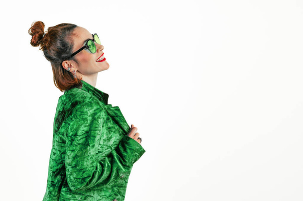 Smiling woman celebrating St. Patrick's Day. Beautiful woman in a green jacket on a white background. - Photo, Image