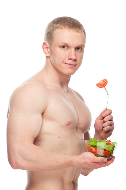 Shaped and healthy body man holding a fresh salad bowl,shaped abdominal, isolated on white background, colored retouched, topless - Foto, afbeelding