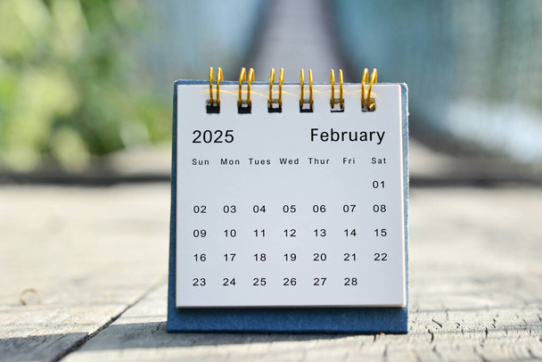February 2025 white calendar with green blurred background. 2024 new year concept. - Photo, Image