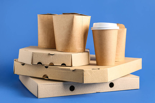 Takeaway paper cup and different boxes on blue background - Photo, Image