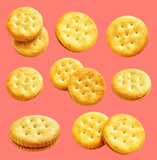 Round crackers isolated or biscuits, butter cookies with clipping path, no shadow in pink background - Photo, Image
