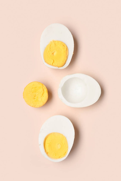 Halves of tasty boiled eggs on pink background - Photo, Image