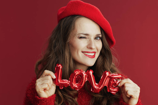 Happy Valentine. smiling elegant 40 years old woman in red sweater and beret with love inscription. - Fotografie, Obrázek