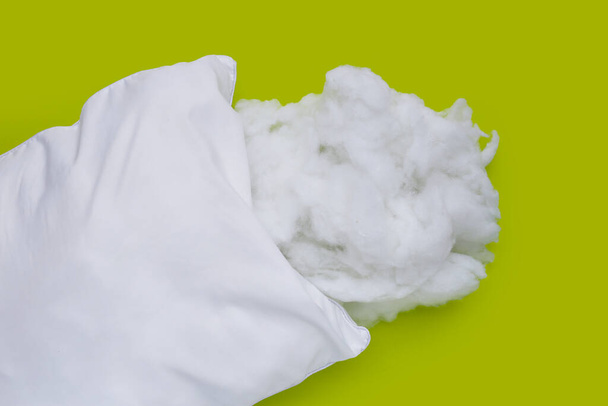 White pillow with polyester stable fiber on green background. - Photo, Image