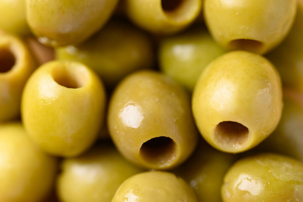 Pickled olives, Pitted green olives texture background - Photo, Image