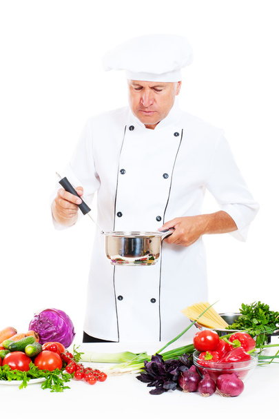 Senior cook holding saucepan - Foto, Imagen