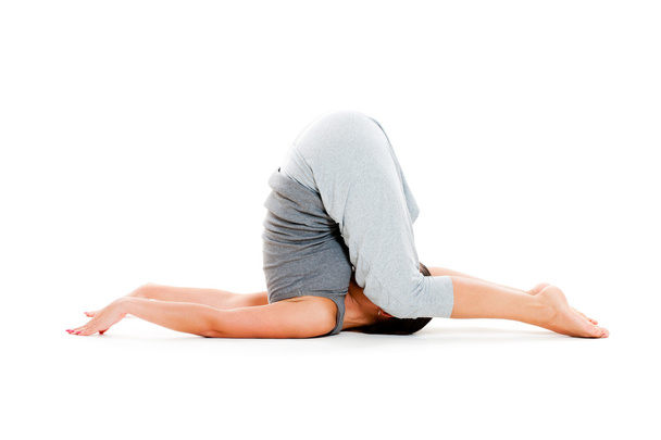 Woman doing yoga workouts on floo - Fotoğraf, Görsel