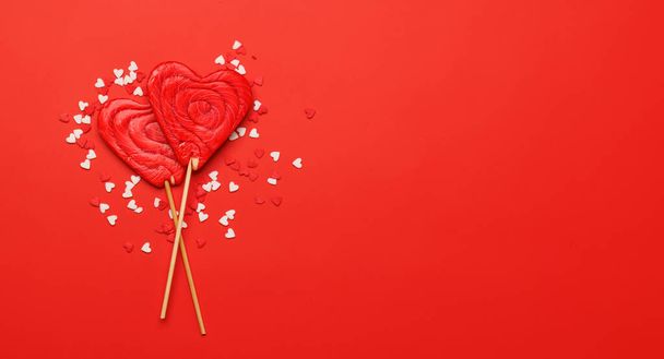 Sydämen tikkarit: Makea kohtelee punaisella taustalla tekstitilalla. Tasainen lay Ystävänpäivä kortti - Valokuva, kuva