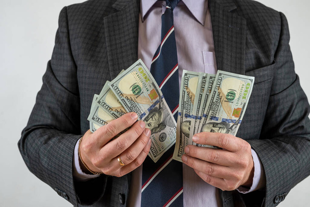 Homem segurando notas de dinheiro isolado fundo cinza. Conceito de investimento financeiro - Foto, Imagem