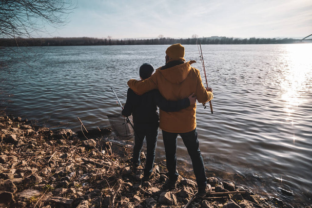 Father and son are ready for fishing on winter day. Freshwater fishing. - Foto, Imagen