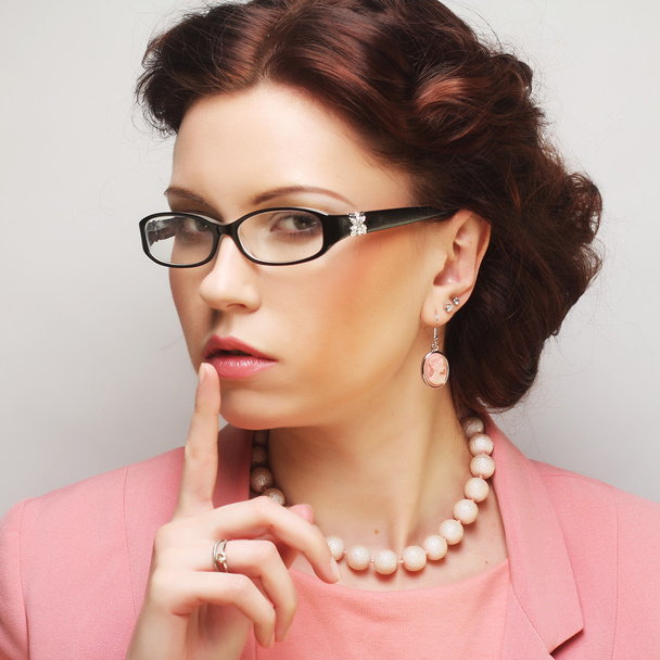 Young businesswoman in pink wearing glasses. - Photo, Image