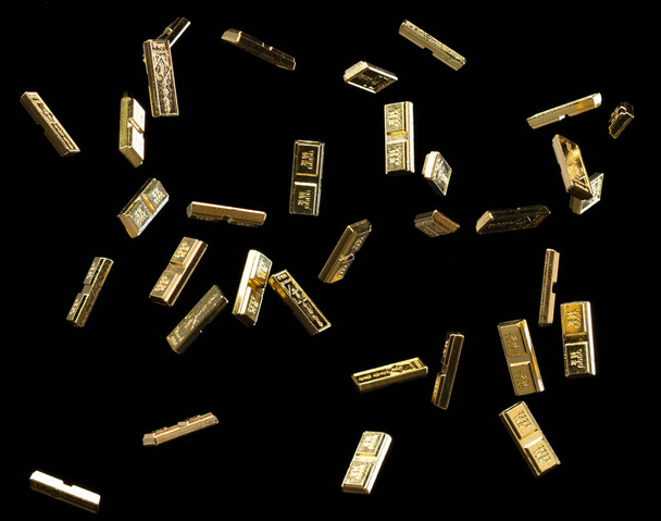 Chinese ornament gold ingot bar. Decoration element of chinese gold ingots or Yuanbao money for Festival. Other language mean rich wealthy prosperity. Black background isolated - Photo, image