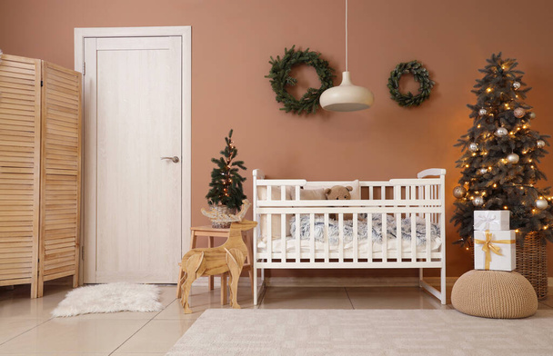 Interior of bedroom with baby crib and Christmas trees - Photo, Image