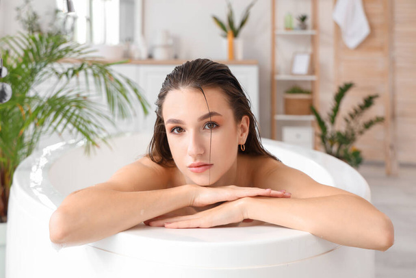 Hermosa mujer con el pelo mojado tomando baño en casa - Foto, Imagen