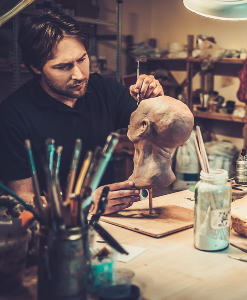 Man working in a prosthetic special fx workshop - Photo, Image