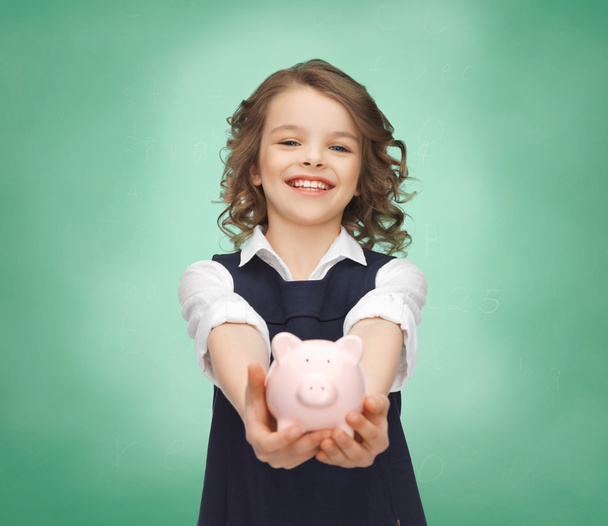 happy girl holding piggy bank on palms - Foto, Imagem