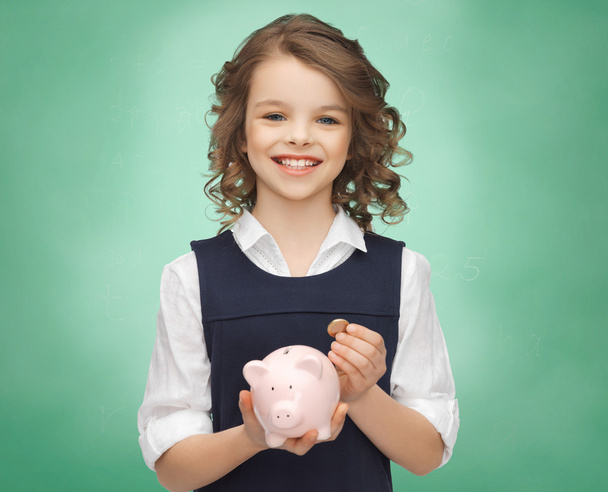happy girl holding piggy bank and coin - Fotoğraf, Görsel