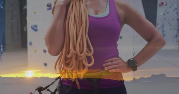 Animation of sunset over caucasian woman by climbing wall. Global sports, science, computing, digital interface and data processing concept digitally generated video. - Filmagem, Vídeo