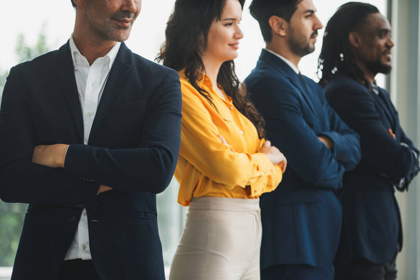 A diverse group of candidates stands together with arms crossed, confident and determined. A Successful businesswoman and her smart team smiling. Cropped side view. Office uniform. Intellectual. - Photo, Image