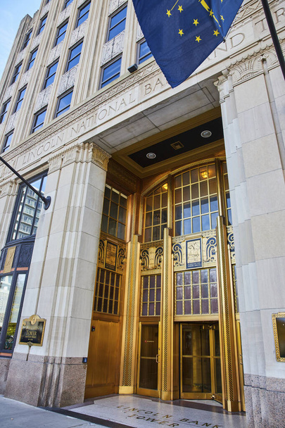 Wielkie wejście Narodowego Banku Lincolna w centrum Fort Wayne w stanie Indiana, z ozdobnymi złotymi drzwiami, detalami architektonicznymi i poczuciem stabilności finansowej. - Zdjęcie, obraz
