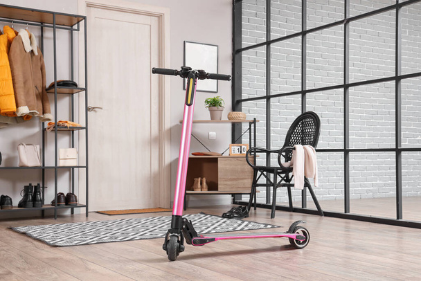 Pink electric scooter in interior of stylish hall - Photo, Image