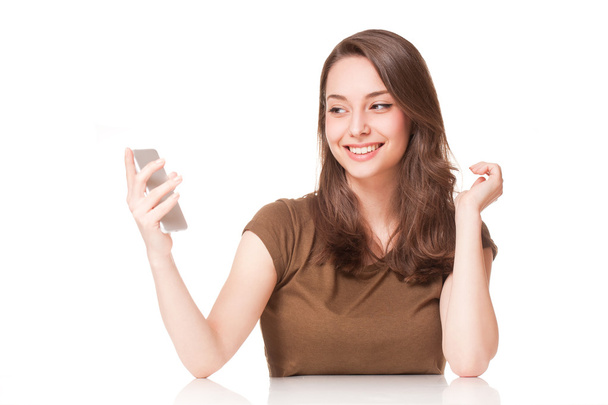 Sweet young brunette using mobile phone. - Foto, Bild